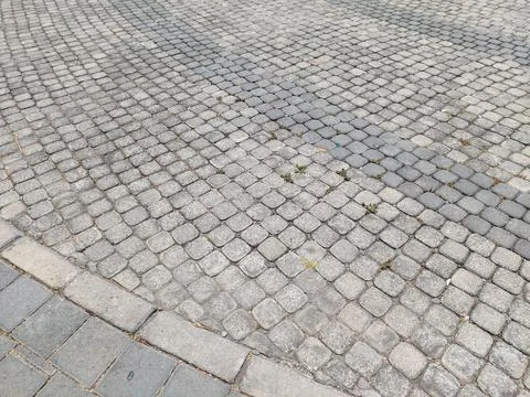 Weathered Surface of Gray Cobblestone Pavement with Curved Pattern Stock Photos