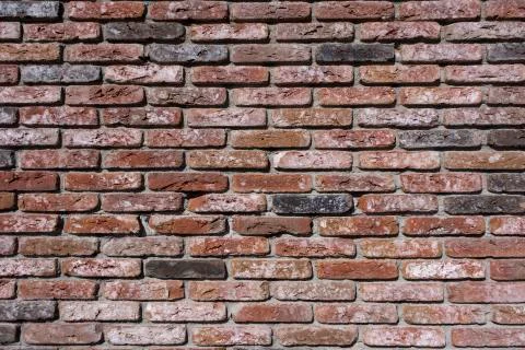 Weathered texture of stained old dark brown and red brick wall background Stock Photos
