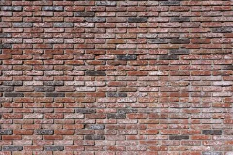 Weathered texture of stained old dark brown and red brick wall background Stock Photos