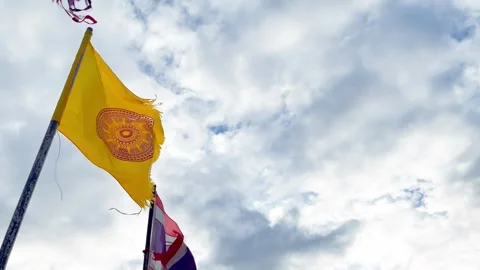Weathered Thai Buddhist Flag and Thailand Flags Waving on Sky at the Temple Stock Footage 321670757