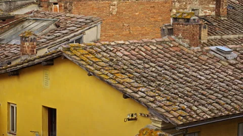 Weathered Tiled Rooftop and Yellow Wall Stock Footage 256040812