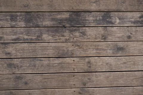Weathered timber deck boards with grooves and screw heads in rows Stock Photos