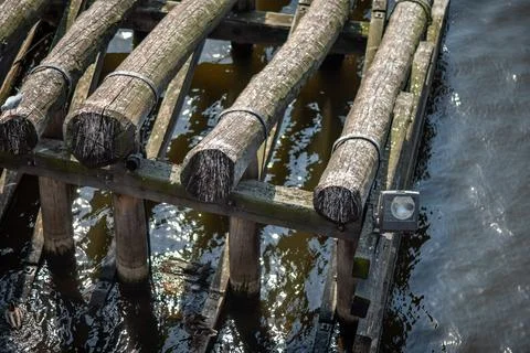Weathered timber dock over rippling water 库存照片