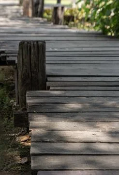 Weathered by time and nature, this rustic boardwalk winds gracefully throug.. Foto stock