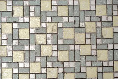 A weathered top-down view of a geometric mosaic tile pattern 写真素材