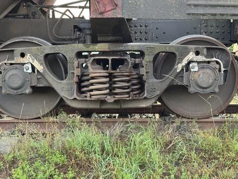 Weathered Train Bogie with Rusty Wheels and Springs on Railway Track Stock Photos