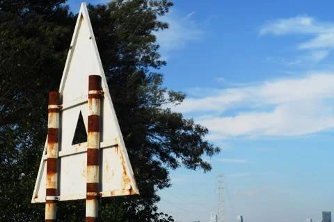 Weathered triangular navigation marker by lake Stock Photos