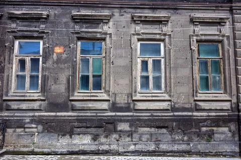 Weathered urban architecture featuring aged stone and broken windows Stock Photos