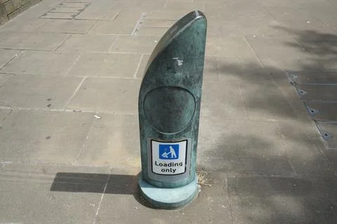 Weathered Verdigris Loading Only Bollard On Paved Street In Sheffield, England. Fotos de archivo
