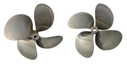 Weathered vintage bronze boat propellers with green patina on clean white b.. Stock Photos