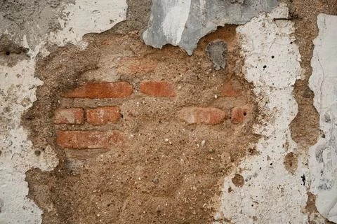 Weathered wall with exposed bricks and plaster Stock Photos