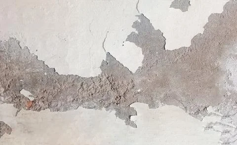 Weathered Wall Texture with Peeling Paint revealing the underlying concrete.. Stock Photos