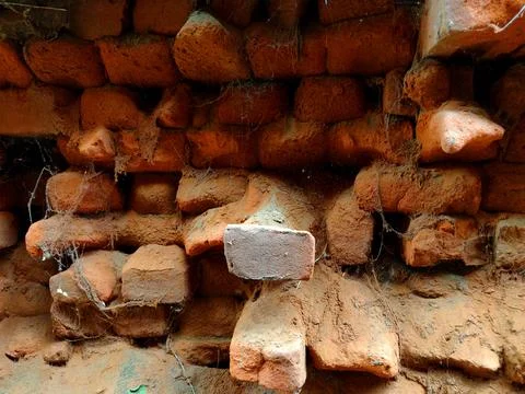 Weathered Walls Red bricks Broken Bricks and decayed Bricks in a wall Stock Photos
