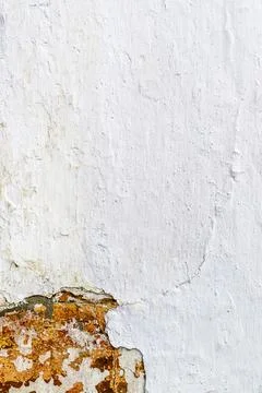 Weathered white plaster wall with peeling paint and exposed texture Stock Photos