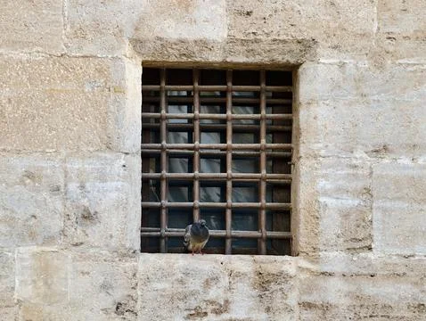 Weathered window with chain, Decayed metal window secured with chain and Stock Photos