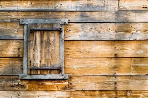 Weathered window frame with shutter on a wooden building Stock Photos