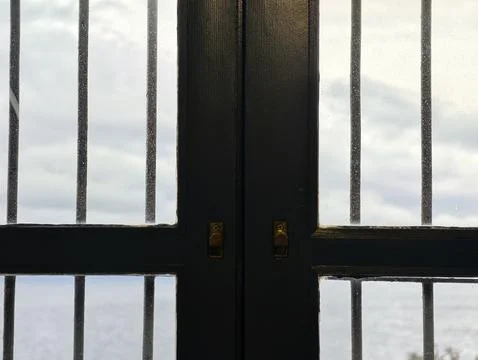 Weathered window view, coastal window with bars and textures, old window fr.. Фото