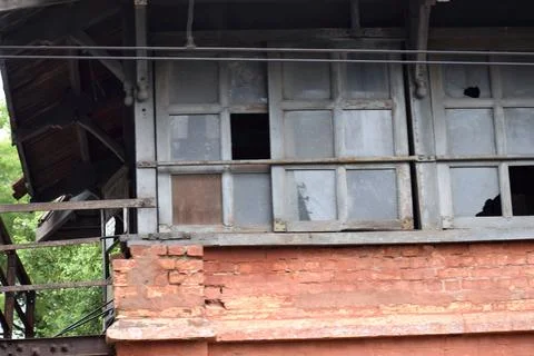 Weathered windows and brick facade of an abandoned historic building Stock Photos