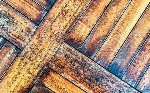 Weathered Wooden Deck With A Herringbone Pattern And Visible Grain Detail Stock Photos