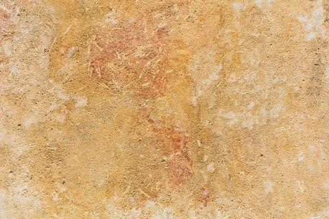 Weathered yellow limestone wall background in Malta, closeup view Stock Photos