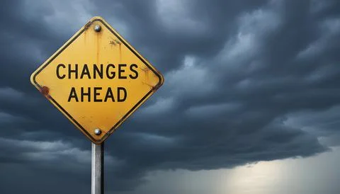 A weathered yellow road sign with 'CHANGES AHEAD' stands starkly Stock Photos