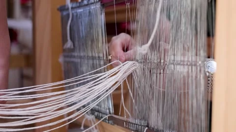 Weaver Separating Warp Threads on Traditional Handloom Stock Footage 337959825