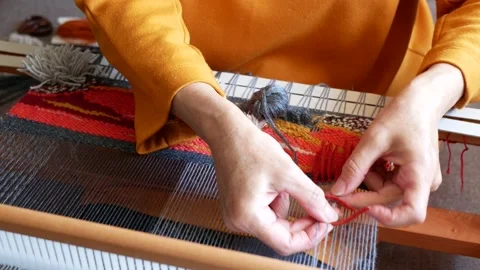 Weaver is tying knots to create a cut pile carpet effect Video stock 156734589