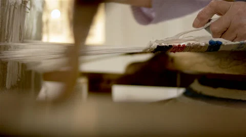 Weaver working on a traditional loom. Video stock 63166992