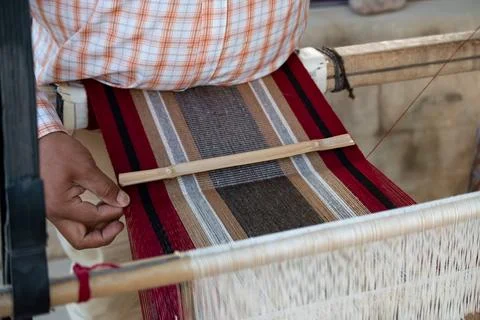 Weaver's hands making a striped textile with llama wool in Argentina. Stock Photos