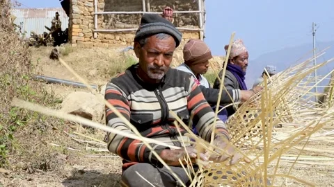 Weaving a bamboo basket by hand in Nepal village Stock Footage 156010331