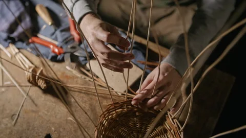 Weaving a basket from willow branches on a table Stock Footage 170202246