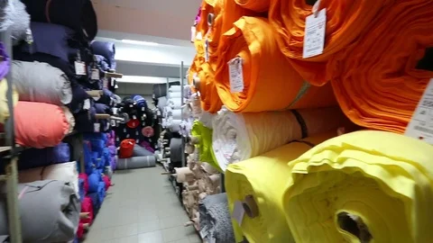 Weaving factory warehouse of rolls of colored fabric Video stock 77989041