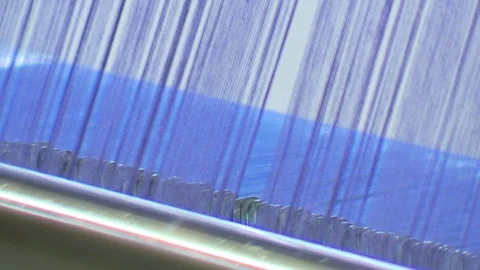 Weaving machine with blue fabric close up Stock Footage 78088437