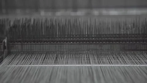 Weaving machine with lots of white threads getting run through it Stock Footage 248798629