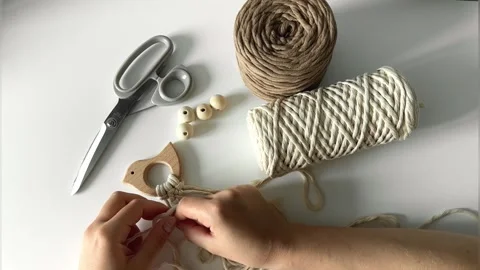 Weaving macrame. The girl weaves macrame. Hand-made. Stock Footage 245266260