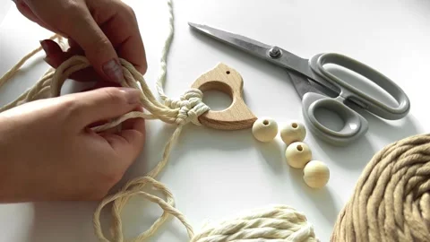 Weaving macrame. The girl weaves macrame. Hand-made. Stock Footage 245266278