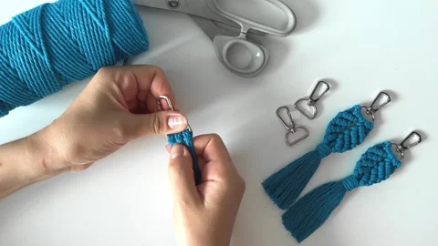 Weaving macrame. The girl weaves macrame. Stock Footage 245305409