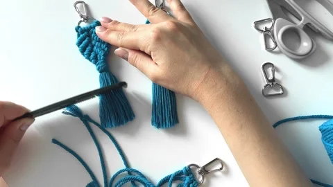 Weaving macrame. The girl weaves macrame. Stock Footage 245305473
