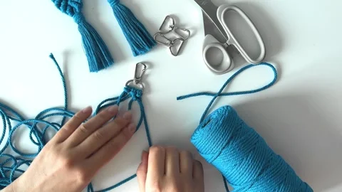 Weaving macrame. The girl weaves macrame. Stock Footage 245306893