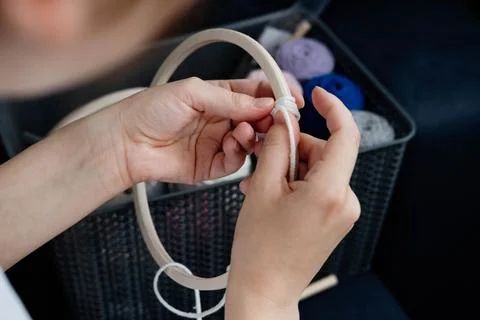 Weaving macrame at home. Hand of a woman when she is making macrame. Stock Photos