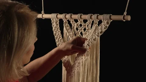 Weaving macrame pattern from natural white cotton threads. Women's hands knit Stock Footage 172241722