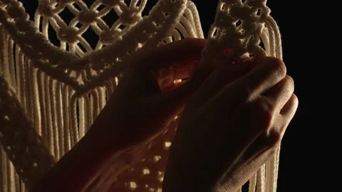 Weaving macrame pattern from natural white cotton threads. Women's hands knit Stock Footage 172241958