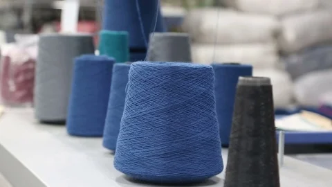 Weaving mill bobbin with blue thread work Stock Footage 77988346