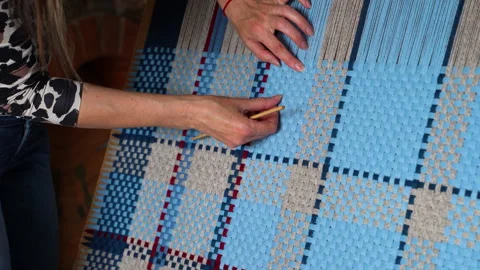 Weaving Pattern with Blue and Beige Yarn on Loom, Hands Adjusting with Tool Stock Footage 277175536