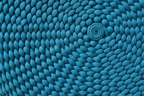 Weaving pattern with a center in a circle. Stock Photos