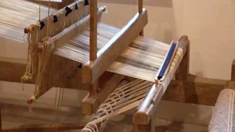 Weaving process on traditional wooden handloom with white and blue yarn Stock Footage 339754596