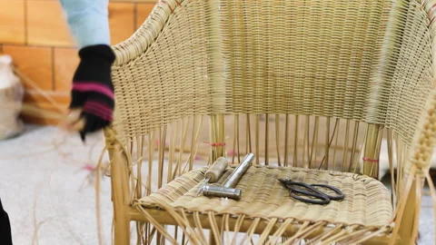 The weaving of a rattan armchair. Stock Footage 320386568