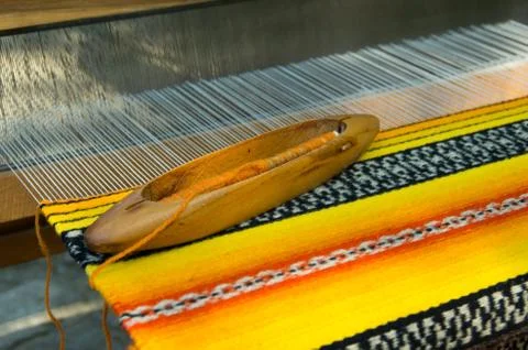 Weaving shuttle on the warp Stock Photos