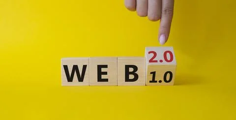 WEB 2 or 1 symbol. Businessman hand points at turned wooden cubes with word.. Foto stock