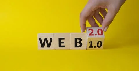 WEB 2 or 1 symbol. Businessman hand Turnes cube and changes word WEB 1.0 to.. 库存照片
